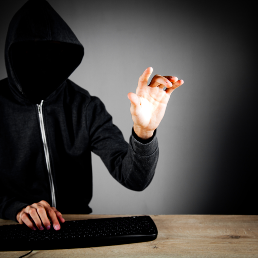 Faceless hacker wearing a black hoodie