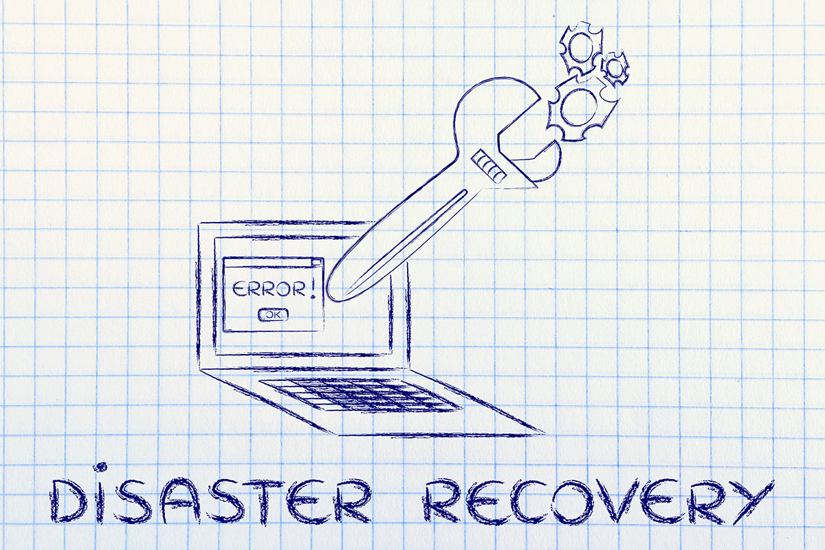 Drawing of oversized wrench coming out of laptop screen on graph paper with words 'disaster recovery'.